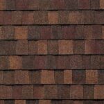 A close-up view of overlapping brown and reddish asphalt roof shingles arranged in a staggered pattern, showing their rough, granular texture.