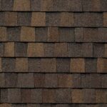 Close-up view of overlapping brown asphalt shingles on a roof, arranged in a staggered pattern. The shingles display different shades of brown, creating a textured and uniform surface.