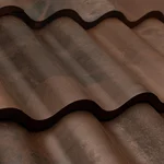 Close-up view of brown, wavy metal roofing sheets with a slightly reflective surface, showing the texture and curved pattern of the material.