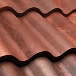 Close-up of wavy, red-brown metal roof tiles with a matte finish and subtle texture.