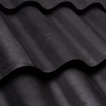 Close-up of dark gray metal roof tiles arranged in a wavy, overlapping pattern, showing the texture and shape of the roofing material.